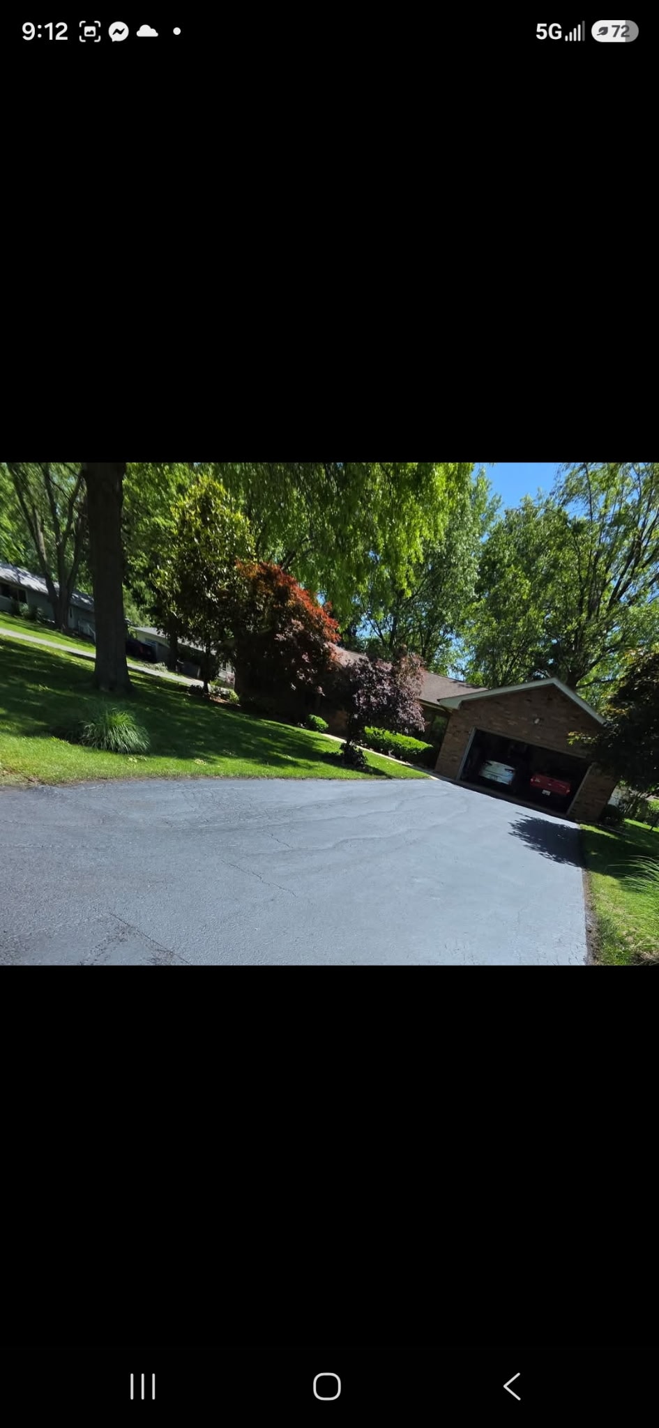 Driveway before sealcoating with caution tape — Silver Lining Asphalt